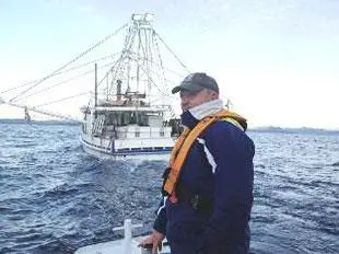 Fisher and fishing boat