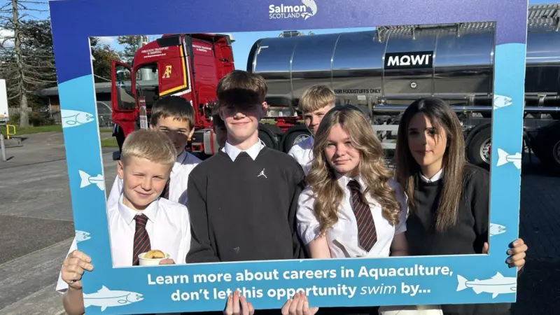 Pupils hold a selfie frame in front of a Fergusons Transport tanker