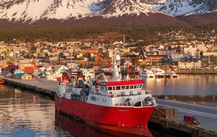 Fishing vessel with mountains behind