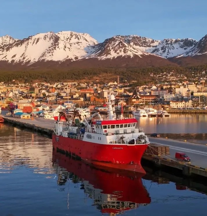 Fishing vessel with mountains behind